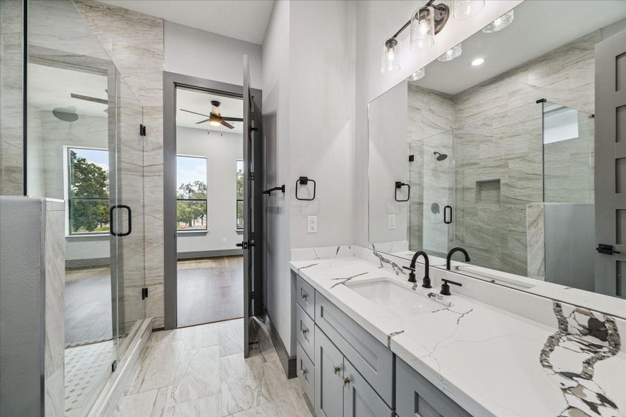 A glass-enclosed shower showcases sleek tile details, complemented by soft lighting that highlights the fresh, contemporary atmosphere. A glass-enclosed shower showcases sleek tile details, complemented by soft lighting that highlights the fresh, contemporary atmosphere.
