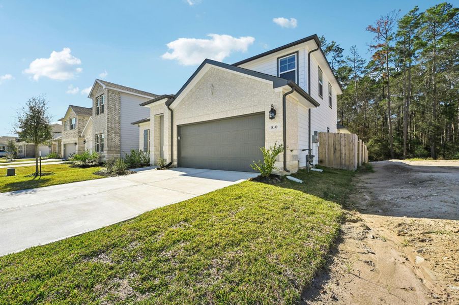 Front exterior of a new home in , New Caney, TX, highlighting curb appeal (Image 27).