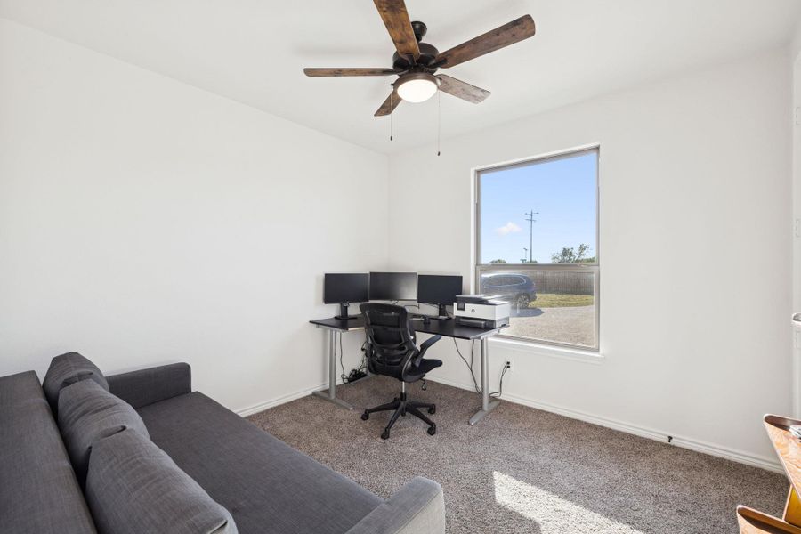 Carpeted home office featuring baseboards and ceiling fan Carpeted home office featuring baseboards and ceiling fan
