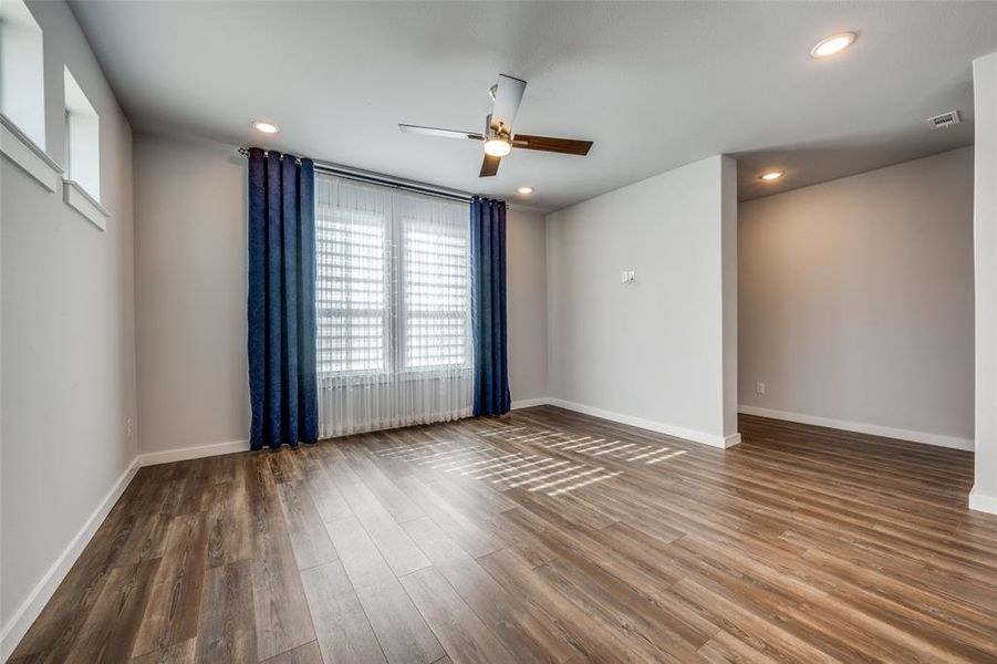 Empty room with recessed lighting, wood finished floors, baseboards, and ceiling fan