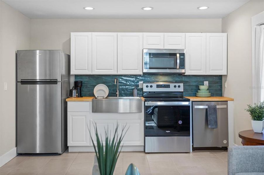 Gorgeous backsplash, apron SS sink & appliances