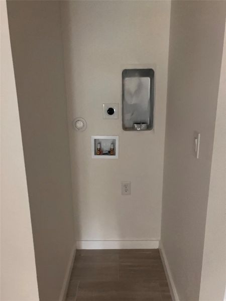Laundry room featuring hookup for a washing machine, hookup for an electric dryer, and dark wood finished floors