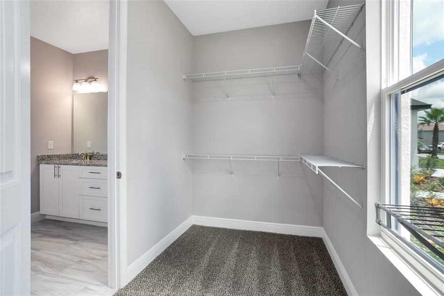 PRIMARY SUITE FEATURES A WALK-IN CLOSET.