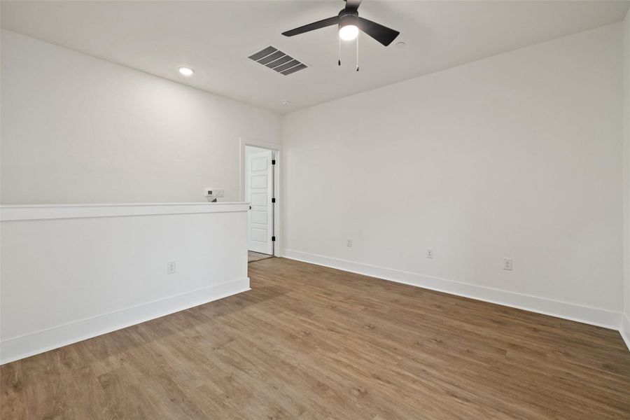 Empty room with wood finished floors, recessed lighting, and a ceiling fan Empty room with wood finished floors, recessed lighting, and a ceiling fan
