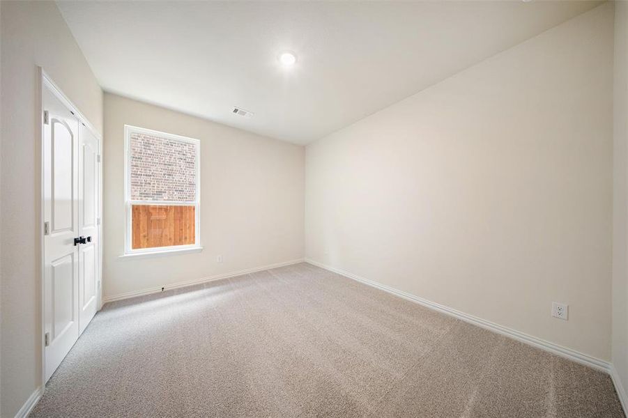 Unfurnished bedroom with carpet flooring and recessed lighting