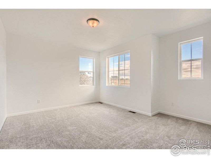 Primary bedroom with lots of natural light