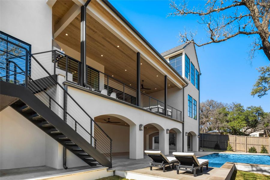 Back of property with a balcony, stucco siding, a ceiling fan, and a patio area Back of property with a balcony, stucco siding, a ceiling fan, and a patio area
