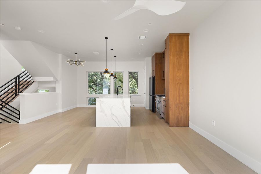 Clean lines and warm wood cabinetry define this modern kitchen with a waterfall island.