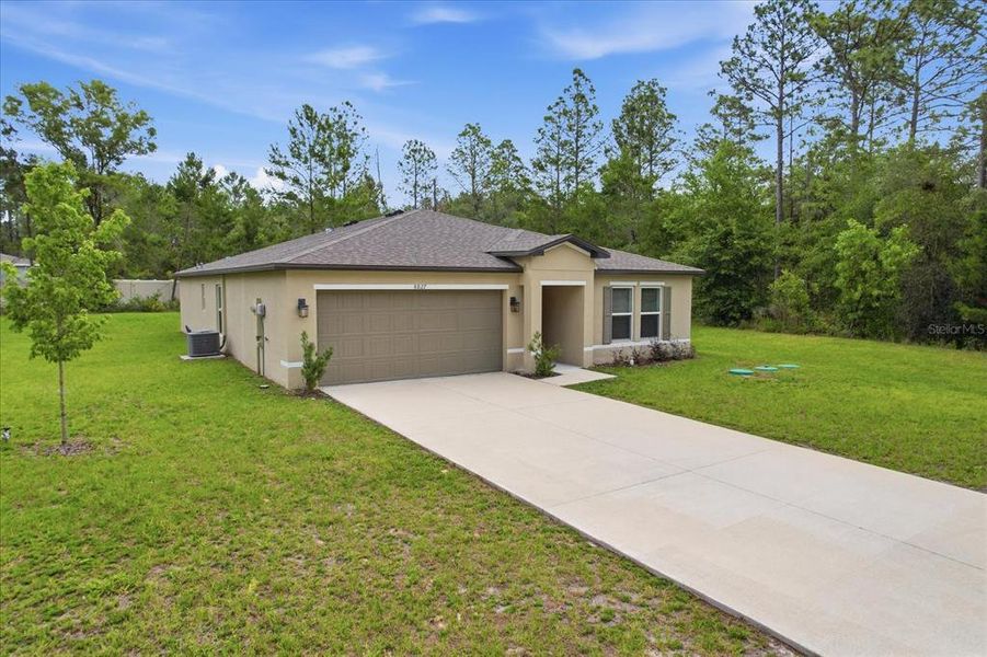 Front exterior of a new home in Citrus Springs, Citrus Springs, FL, highlighting curb appeal (Image 2). Front exterior of a new home in Citrus Springs, Citrus Springs, FL, highlighting curb appeal (Image 2).