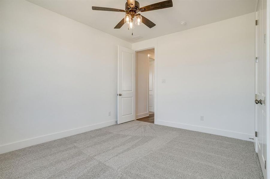 Spare room with light carpet and ceiling fan Spare room with light carpet and ceiling fan