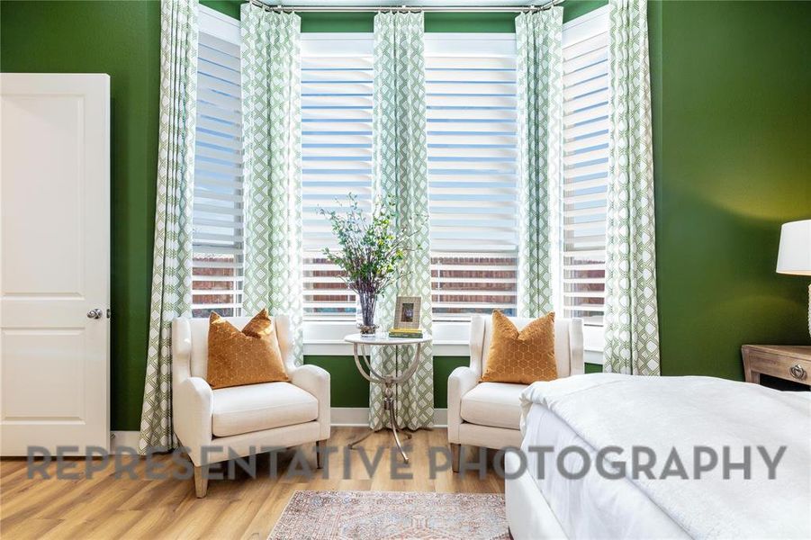 Bedroom with wood finished floors and multiple windows Bedroom with wood finished floors and multiple windows