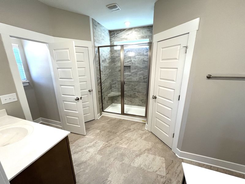 The happy marriage bathroom with split vanities, split closets and private toilet area