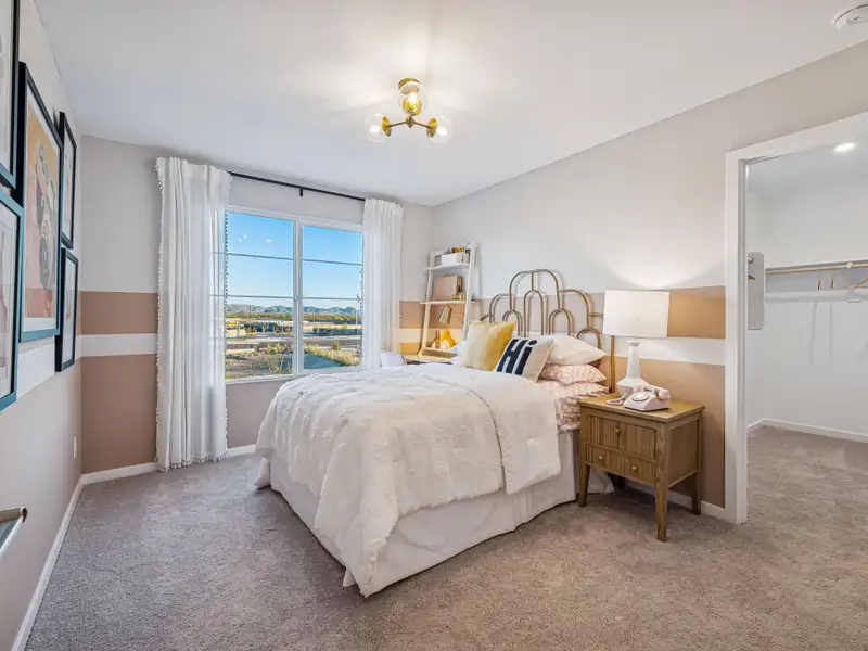 A bedroom with a large window.