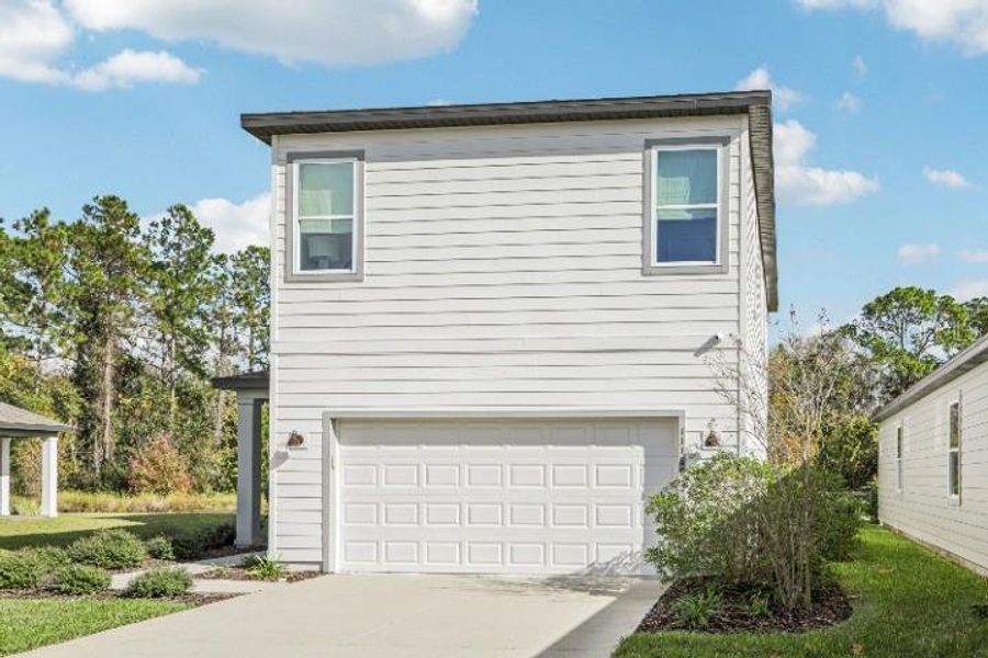 Front exterior of a new home in Northlake Classical, Winter Garden, FL, highlighting curb appeal (Image 24). Front exterior of a new home in Northlake Classical, Winter Garden, FL, highlighting curb appeal (Image 24).