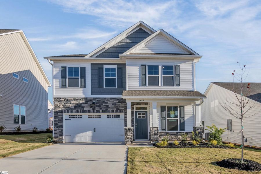 Front exterior of a new home in Halton Oaks, Spartanburg, SC, highlighting curb appeal (Image 2).