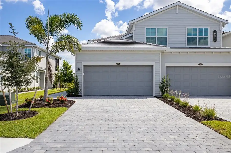 Front exterior of a new home in Calusa Country Club, Lakewood Ranch, FL, highlighting curb appeal (Image 24).