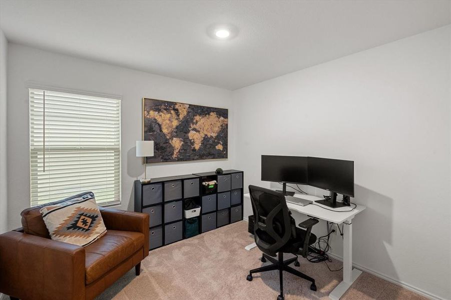 Carpeted office space featuring baseboards