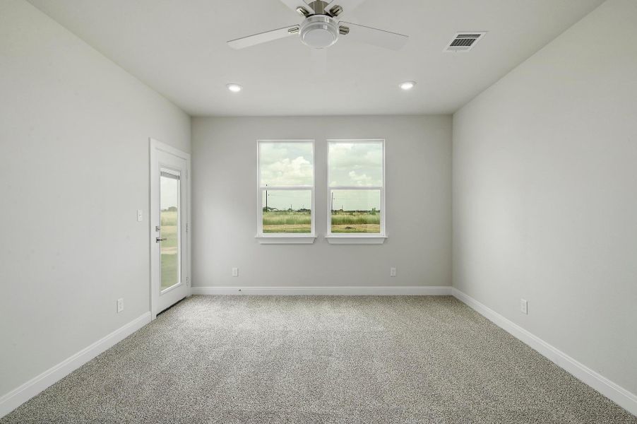 Spare room featuring carpet, plenty of natural light, ceiling fan, and recessed lighting Spare room featuring carpet, plenty of natural light, ceiling fan, and recessed lighting
