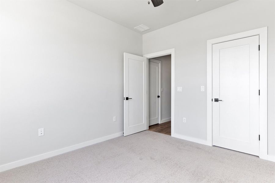 Unfurnished bedroom with carpet floors and ceiling fan