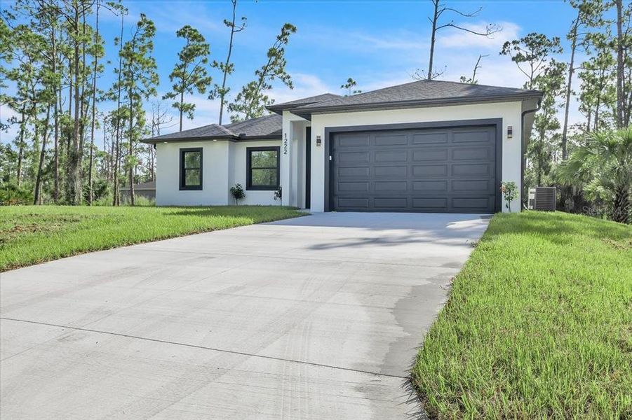 Front exterior of a new home in , Port Charlotte, FL, highlighting curb appeal (Image 26). Front exterior of a new home in , Port Charlotte, FL, highlighting curb appeal (Image 26).