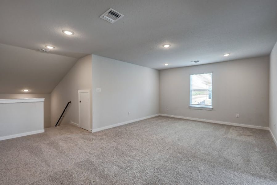 A room with a carpet and a door. A room with a carpet and a door.