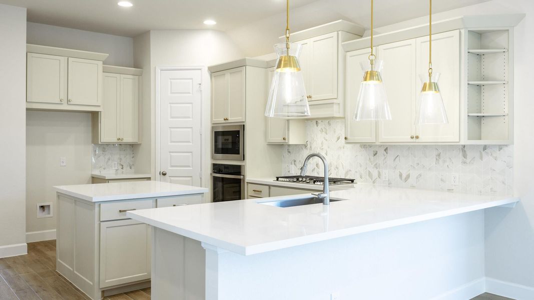 Kitchen featuring a peninsula, decorative backsplash, recessed lighting, open shelves, and appliances with stainless steel finishes Kitchen featuring a peninsula, decorative backsplash, recessed lighting, open shelves, and appliances with stainless steel finishes