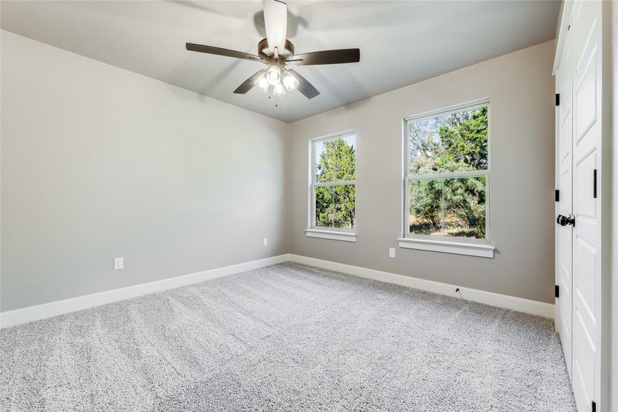 Unfurnished room with light carpet and a ceiling fan Unfurnished room with light carpet and a ceiling fan