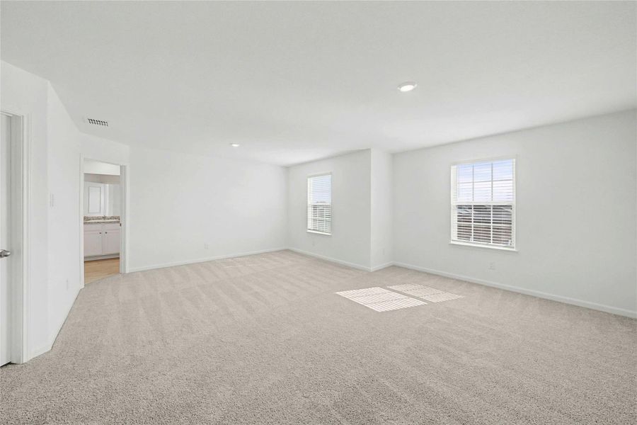 Unfurnished room with light carpet and recessed lighting