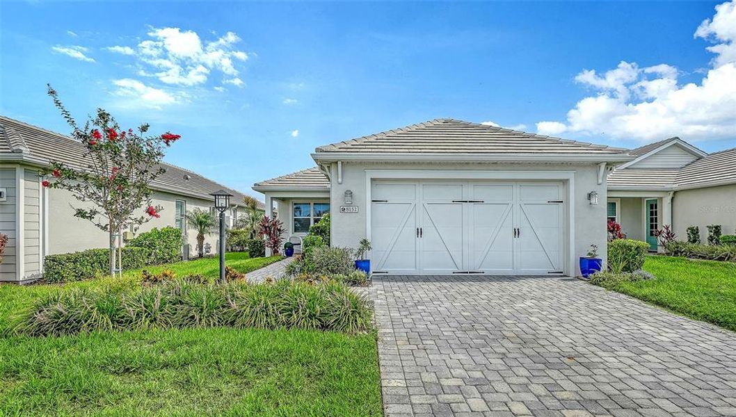 Front exterior of a new home in LakeHouse Cove at Waterside, Sarasota, FL, highlighting curb appeal (Image 2). Front exterior of a new home in LakeHouse Cove at Waterside, Sarasota, FL, highlighting curb appeal (Image 2).
