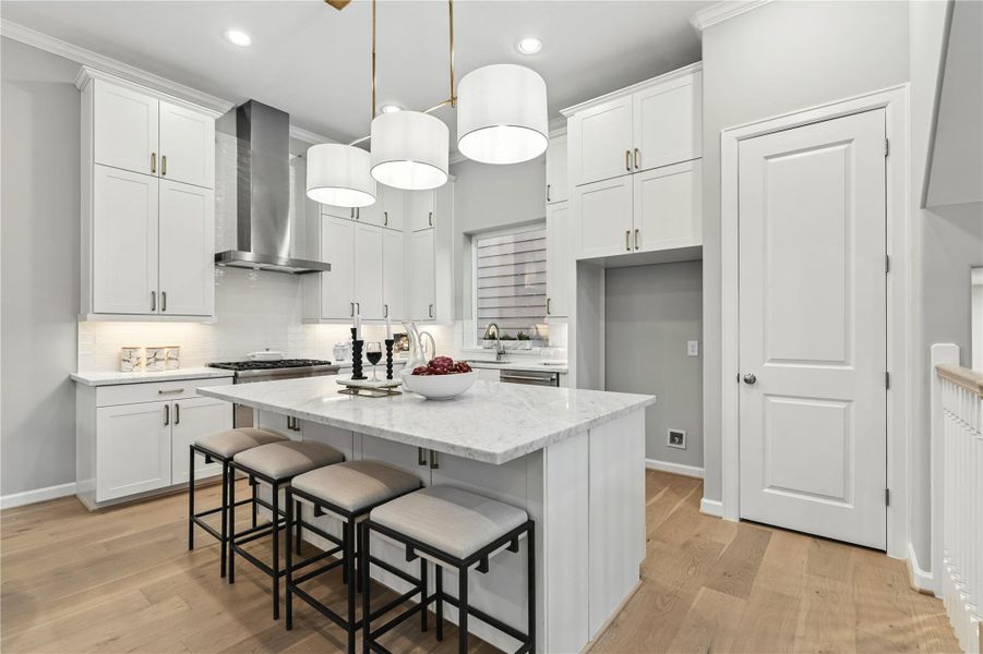 The well-appointed kitchen and island. Equipped with designer lighting and Thermador appliances.