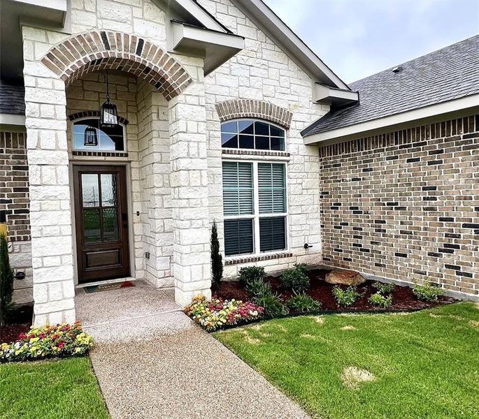 Stone and brick exterior with an arched entryway Stone and brick exterior with an arched entryway