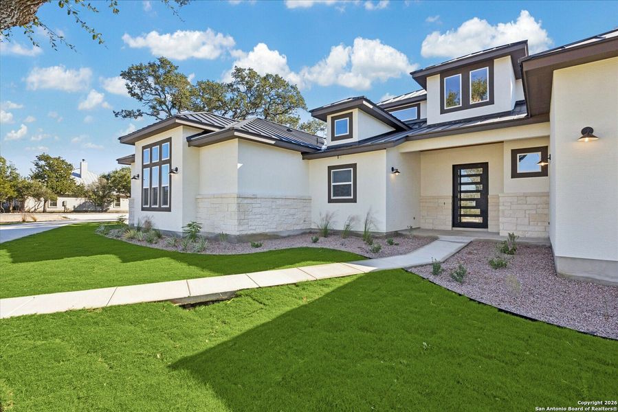 Front exterior of a new home in , Bulverde, TX, highlighting curb appeal (Image 27).