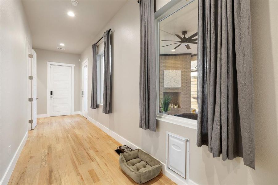 Corridor with hardwood / wood-style flooring