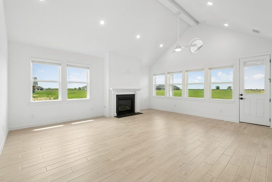 Bright and open dining area and great room with fireplace Bright and open dining area and great room with fireplace