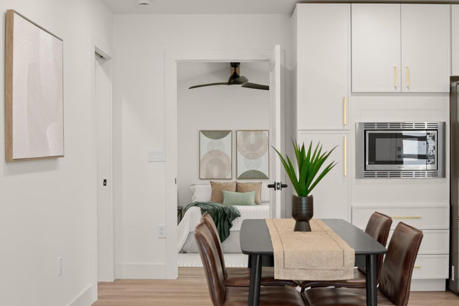 Dining area with light wood-style floors and ceiling fan