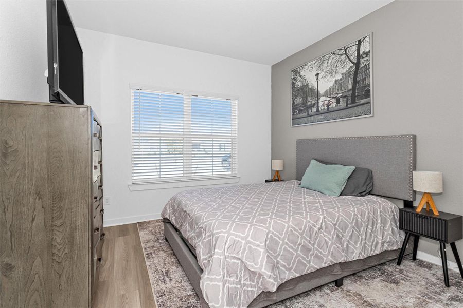 This first-floor secondary bedroom, conveniently located off the entryway, features natural light and a comfortable layout—making it ideal for guests, a home office, or visiting family members seeking easy, accessible living.