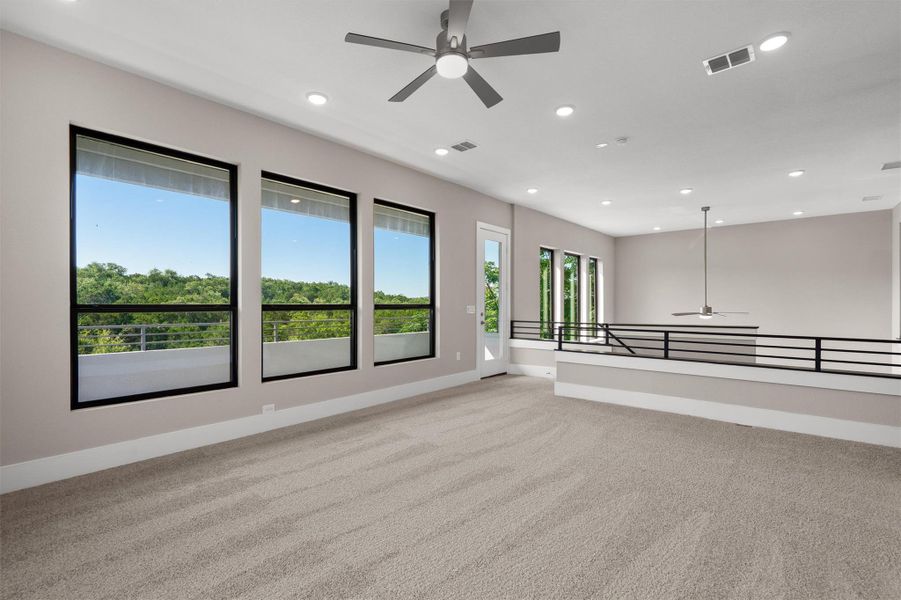 Unwind in this generously sized loft, featuring treetop views from vast windows and integrated ceiling lights. Unwind in this generously sized loft, featuring treetop views from vast windows and integrated ceiling lights.