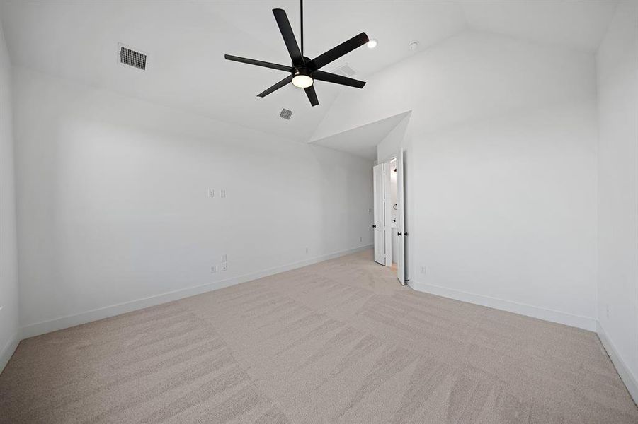 Unfurnished room with light colored carpet, high vaulted ceiling, and ceiling fan