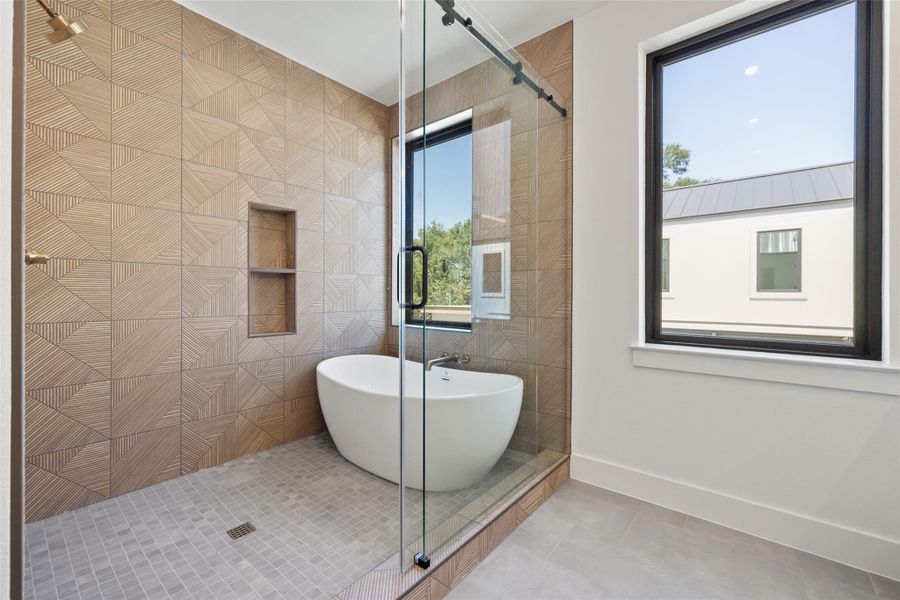 Bathroom with a stall shower, a soaking tub, and tile patterned floors