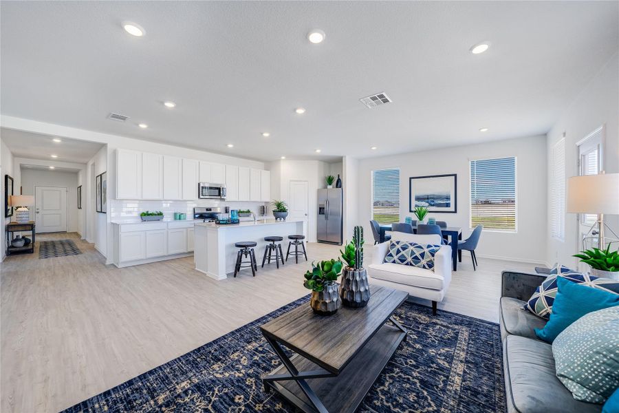 Living area with light wood-style flooring, plenty of natural light, and recessed lighting