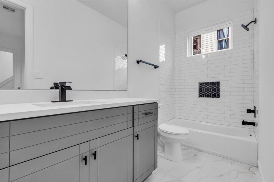 This inviting first-floor bathroom boasts a sleek, modern design with a convenient combo tub and shower, perfect for relaxation and functionality. This inviting first-floor bathroom boasts a sleek, modern design with a convenient combo tub and shower, perfect for relaxation and functionality.