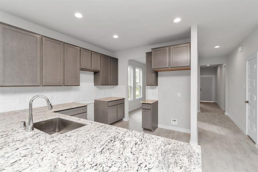 This generously spacious kitchen is a dream realized! Sample photo of completed home with similar floor plan. As-built interior colors and selections may vary.