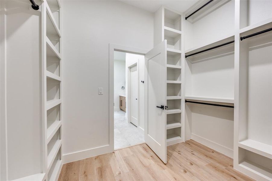 Spacious closet featuring light wood-type flooring