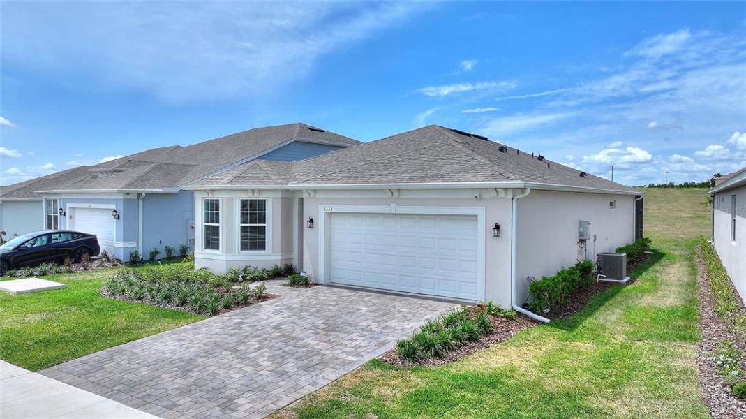 Front exterior of a new home in , Minneola, FL, highlighting curb appeal (Image 21).