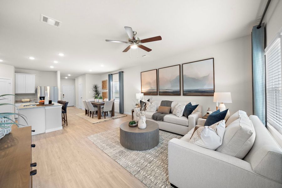 A living room with a large ceiling fan.