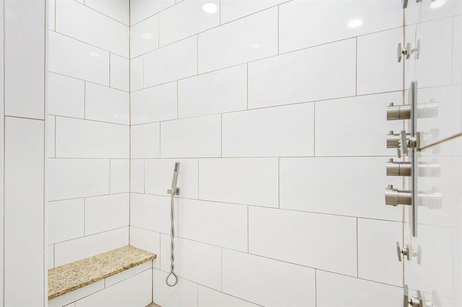 Full bath featuring tiled shower