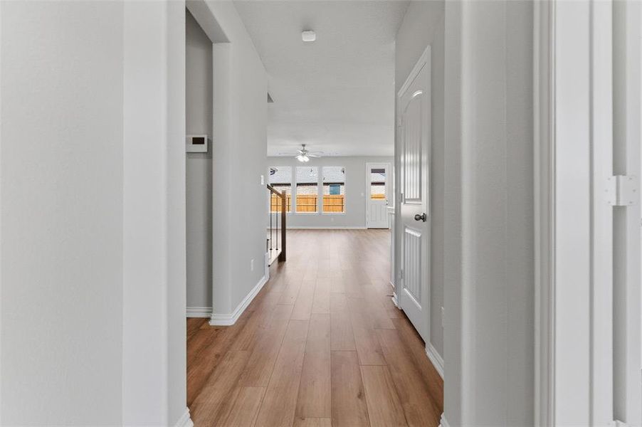 Corridor featuring baseboards and light wood-type flooring
