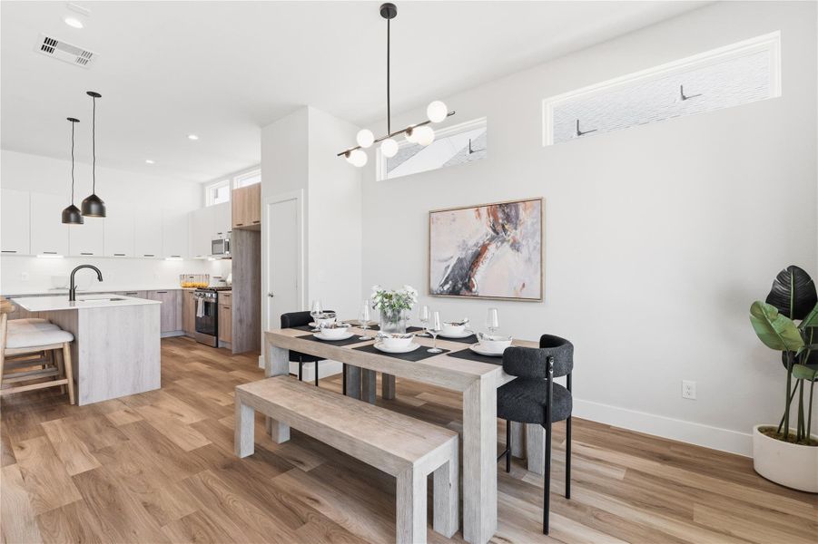 Purposefully placed clerestory windows bring consistent natural light deep into the home, elevating the open layout and allowing the kitchen, dining, and living spaces to function as one cohesive entertaining level.