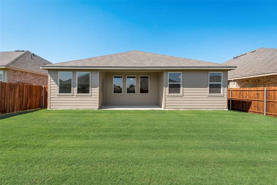 Back of house with a patio area and a yard