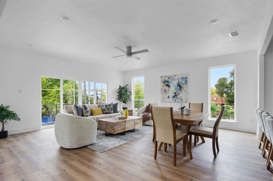 Dining room with light hardwood / wood-style floors and ceiling fan